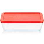 Clear glass food storage container with a red lid on a white background