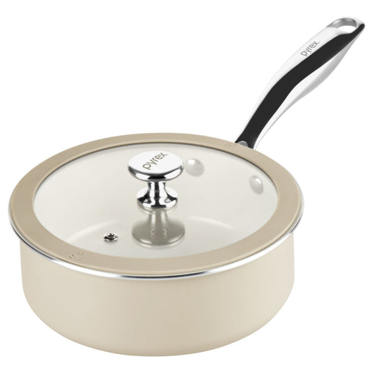 Cream-colored saucepan with glass lid and black handle on a white background