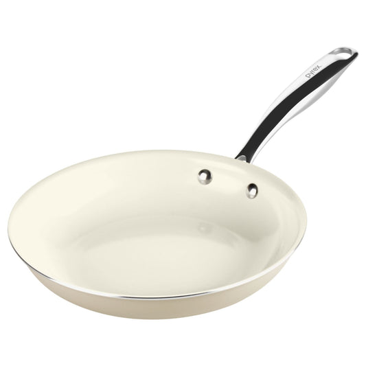 White frying pan with a black handle on a white background