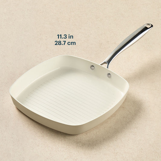 White square frying pan with measurement text on a beige background